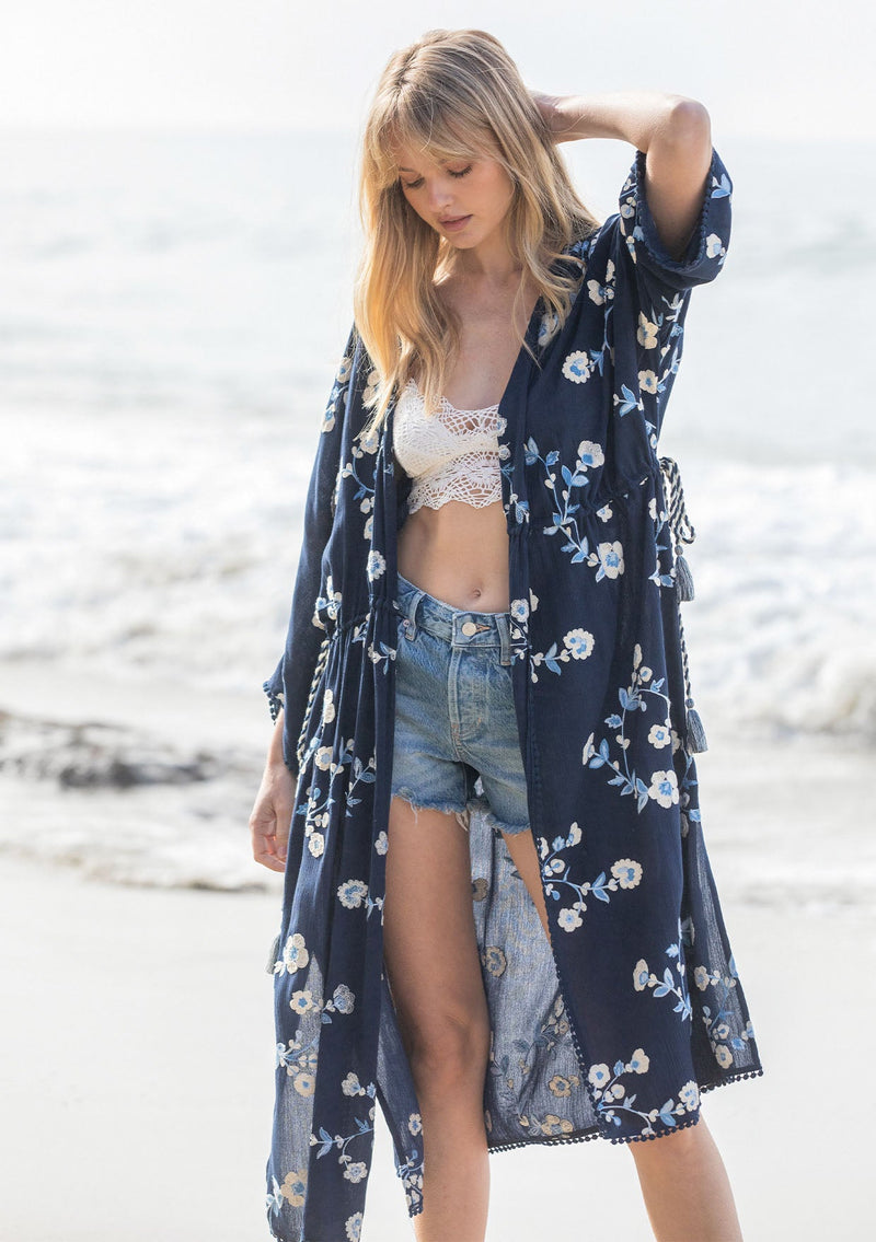 [Color: Navy/Ivory] A model wearing a bohemian navy blue mid length kimono with floral embroidery.