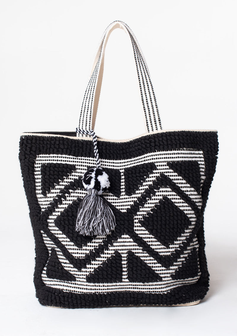 [Color: Black/White] An oversize black and white bohemian carpet tote bag.