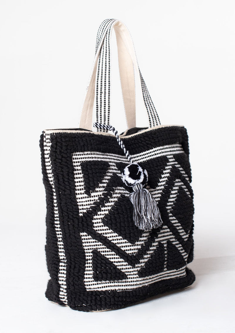 [Color: Black/White] An oversize black and white bohemian carpet tote bag.