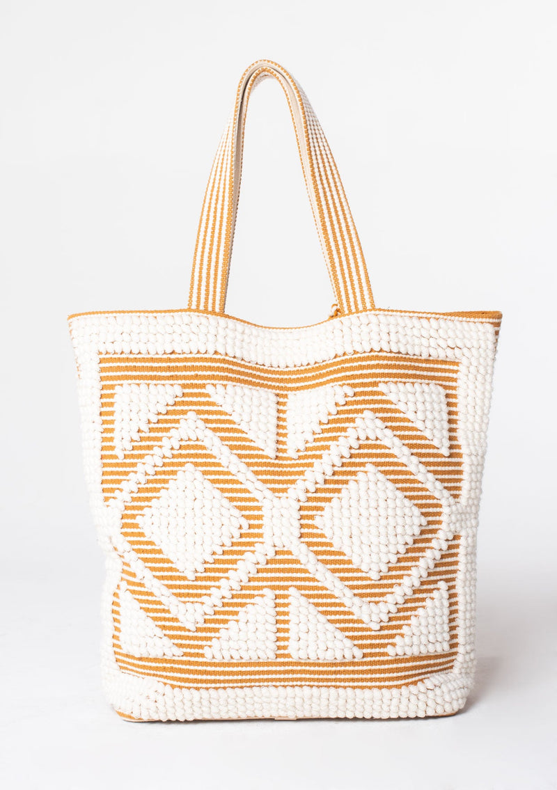 [Color: White/Saddle] An oversize white and brown bohemian carpet tote bag.