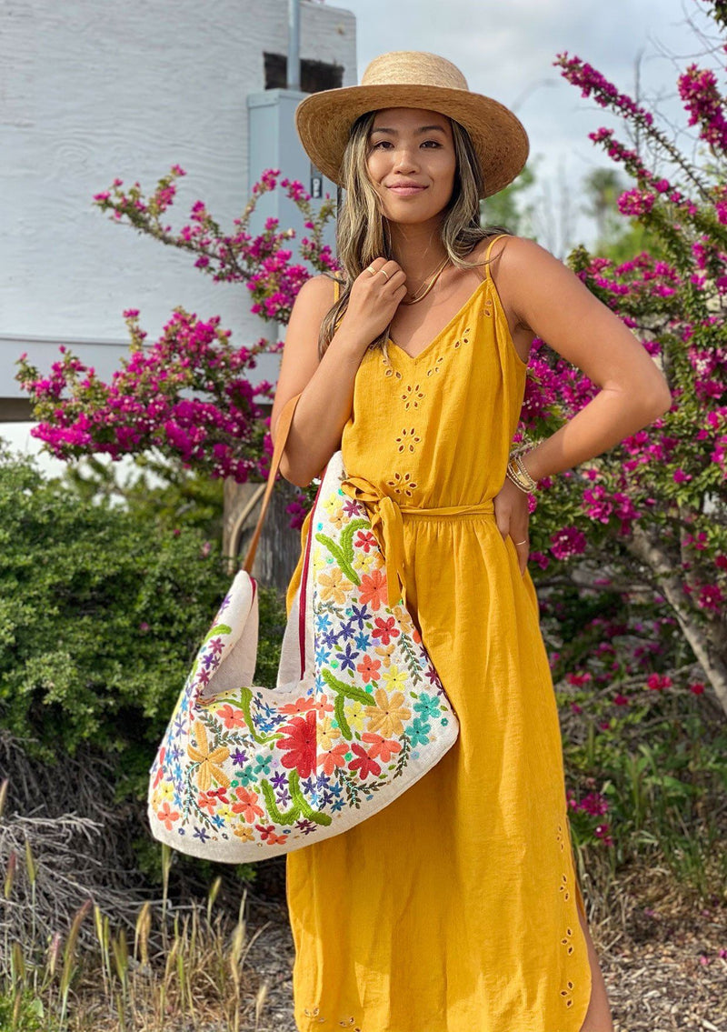 [Color: Multi/Natural] A slouchy tote bag with colorful embroidered floral details on the front side of the bag. With a suede leather strap. 