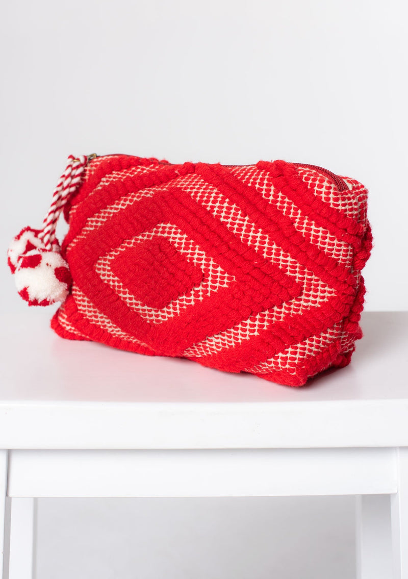 [Color: Red] A red bohemian carpet makeup bag with pom tassel. 