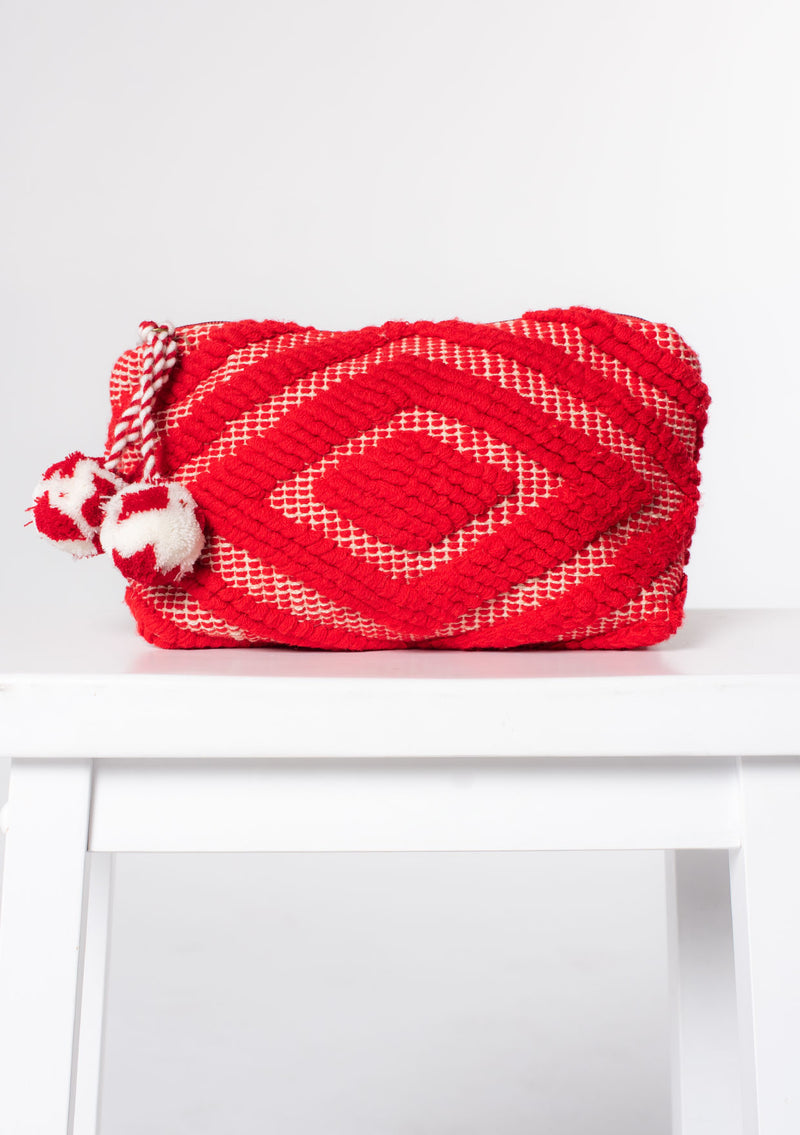 [Color: Red] A red bohemian carpet makeup bag with pom tassel. 