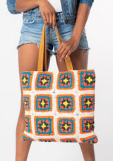 [Color: Natural/Blue] A natural, off white cotton crochet knit tote bag with retro blue and orange design and suede leather handles. 