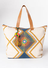 [Color: Natural/Navy] A bohemian oversized travel weekender bag with embroidered sunburst motif and double leather strap handles. 