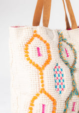 [Color: Natural/Fuchsia] An off white and fuchsia pink bohemian carpet tote bag with brown suede leather handles. 