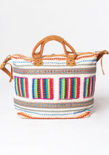 [Color: Natural Multi] A bohemian oversized weekender travel bag with multi colored embroidered detail, zippered closure, and suede leather handles and strap. 