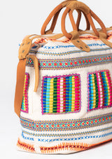 [Color: Natural Multi] A bohemian oversized weekender travel bag with multi colored embroidered detail, zippered closure, and suede leather handles and strap. 