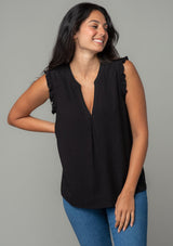 [Color: Black] A front facing image of a brunette model wearing a black linen blend bohemian top with short ruffled cap sleeves, a v neckline, and a flowy silhouette.