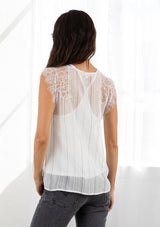 [Color: Grey/Off White] A model wearing a striped camisole tank top with a lace trim v neckline and straps.