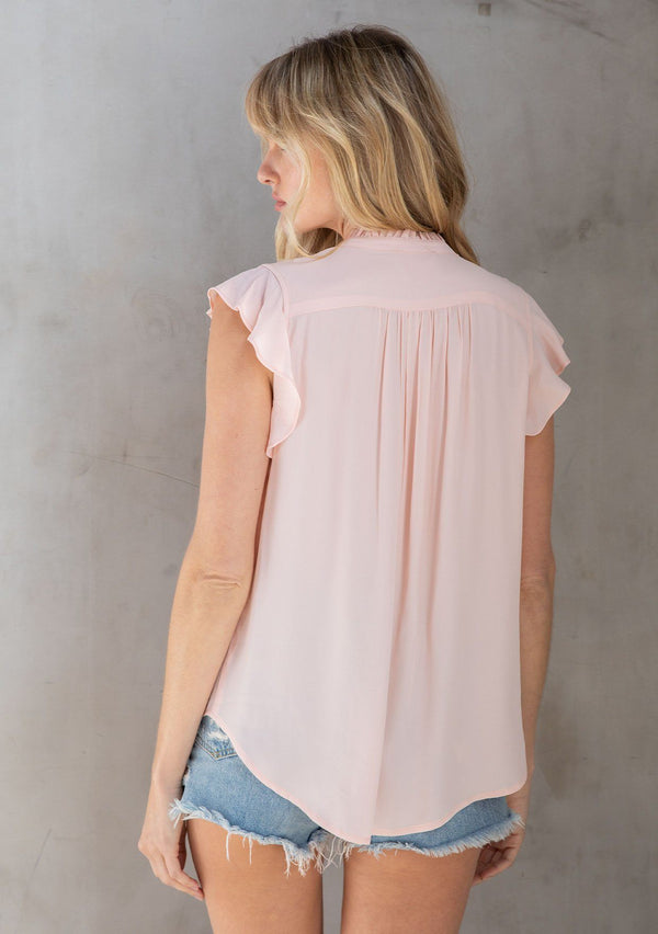 [Color: Bellini] A classic light pink bohemian top, designed in silky crepe. With short flutter cap sleeves and a self covered button front. 