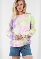 [Color: Lime/Lavender Combo] A blond model wearing a cotton tie dye sweatshirt. Featuring a classic crew neckline and long raglan sleeves.