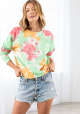 [Color: Red/Green Combo] A model wearing a red and green cotton tie dye sweatshirt. Featuring a classic crew neckline and long raglan sleeves.