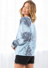[Color: Sky Blue/Grey Combo] A model wearing a blue and grey cotton tie dye sweatshirt. Featuring a classic crew neckline and long raglan sleeves.