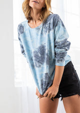 [Color: Sky Blue/Grey Combo] A model wearing a blue and grey cotton tie dye sweatshirt. Featuring a classic crew neckline and long raglan sleeves.