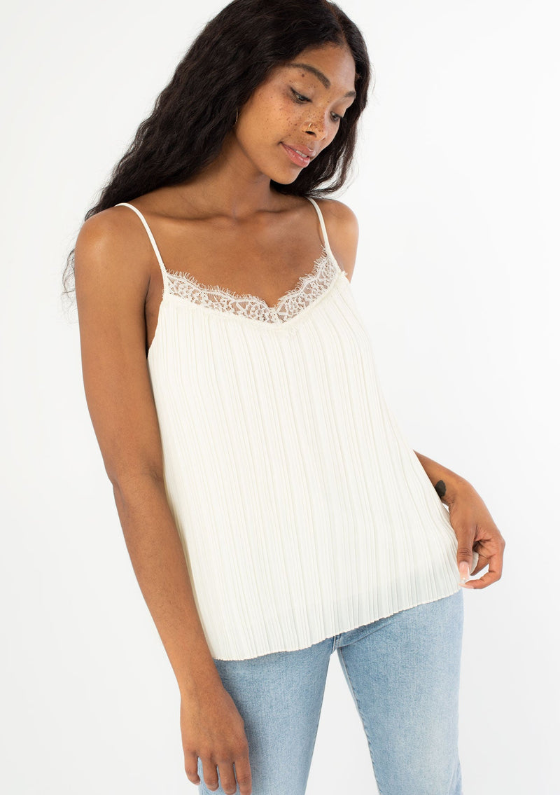 [Color: Ivory] A slinky camisole in a variegated pleated chiffon. Featuring a delicate eyelash lace trim v-neckline, a sexy scoop back, and elegant pleating throughout.
