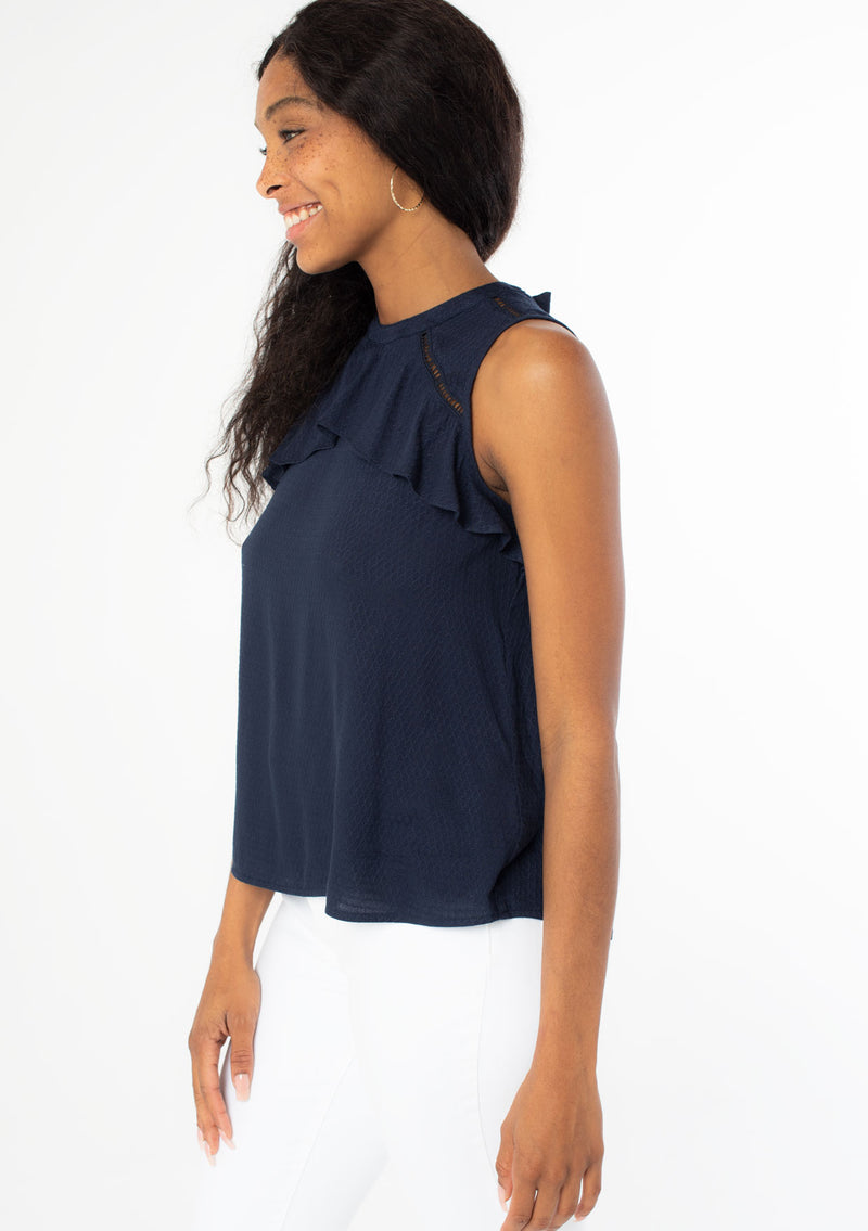 [Color: Navy] Add a touch of whimsy to your outfit with our sleeveless ruffle top in a textured jacquard. Featuring a pretty tie back detail at the neckline and a flirty ruffle trim yoke detail. This adorable top can be worn casually with your favorite denim shorts or dressed up for a cute office look.