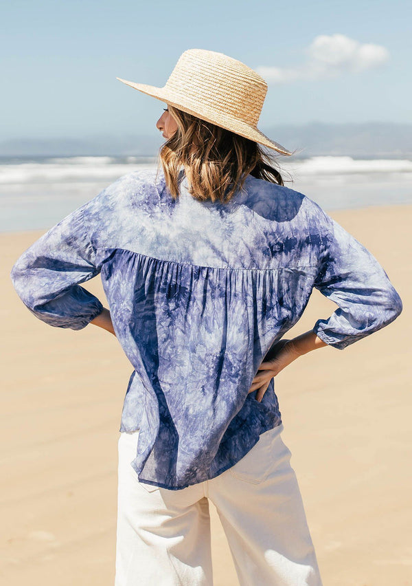 [Color: Navy] A classic peasant blouse in dreamy tie dye. Featuring voluminous three quarter length sleeves, a flattering v neckline, and a hidden button up front.