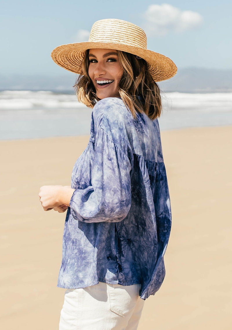 [Color: Navy] A classic peasant blouse in dreamy tie dye. Featuring voluminous three quarter length sleeves, a flattering v neckline, and a hidden button up front.