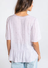 [Color: Orchid Tint] A model wearing a flowy light purple short sleeve top.