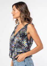 [Color: Black/Blue] A woman wearing a black sleeveless tank top with a blue tropical palm print and a tie shoulder accent. 