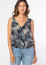 [Color: Black/Blue] A woman wearing a black sleeveless tank top with a blue tropical palm print and a tie shoulder accent. 