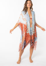 [Color: Light Blue/Red] A model wearing an abstract blue and red floral print mid length kimono. With half length kimono sleeves, an open front, and side slits.