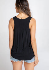 [Color: Black] A model wearing an ultra soft and lightweight black tank top in subtle striped jacquard. With a loose and flowy silhouette, a v neckline, and smocked yoke detail.