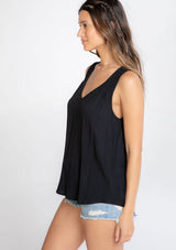 [Color: Black] A model wearing an ultra soft and lightweight black tank top in subtle striped jacquard. With a loose and flowy silhouette, a v neckline, and smocked yoke detail.