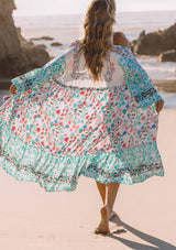 [Color: Jade/Berry] A model wearing a teal, white and pink floral print maxi kimono with long wide sleeves and a rope tie front.