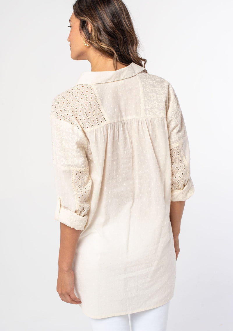 [Color: Natural] A woman wearing a bohemian off white long sleeve cotton tunic top with button front and embroidered detail. 