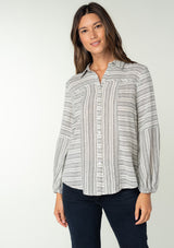 [Color: White/Black] A front facing image of a brunette model wearing a classic bohemian shirt in a white and black stripe. With a button front, long sleeves, and a classic collared neckline. 