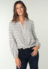[Color: White/Black] A half body front facing image of a brunette model wearing a classic bohemian shirt in a white and black stripe. With a button front, long sleeves, and a classic collared neckline. 