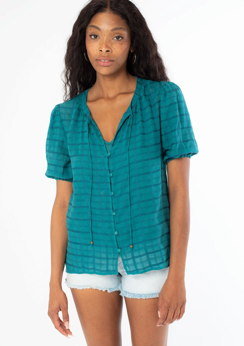 [Color: Teal] A front facing image of a black model wearing a bohemian teal cotton button front top with short puff sleeves.