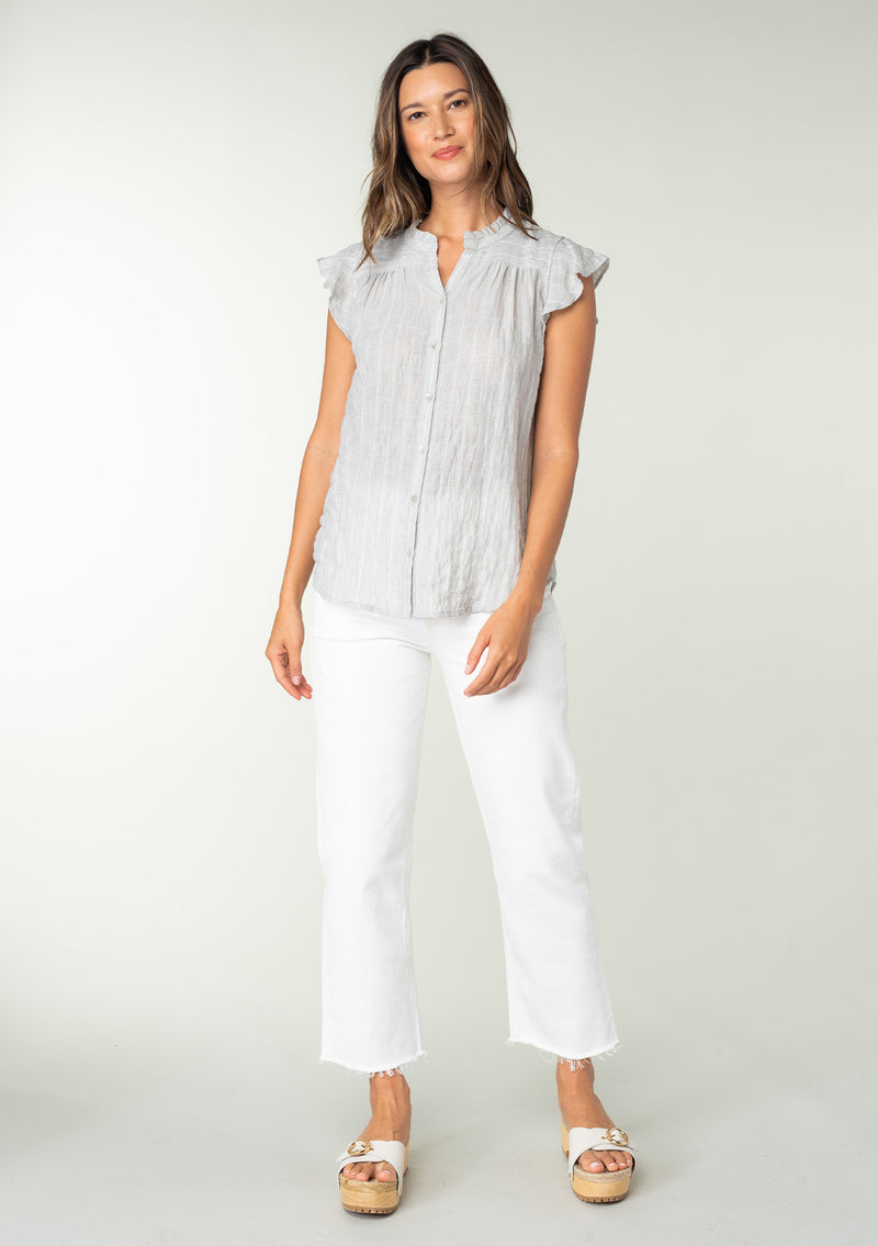 [Color: Heather Grey] A full body front facing image of a brunette model wearing a sheer cotton button front top in a striped jacquard. With short flutter sleeves and a ruffled neckline. A best selling bohemian top. 