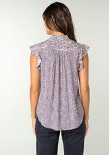 [Color: Grey/Natural] A back facing image of a brunette model wearing a best selling Lovestitch button front top in a grey and natural floral print. With short flutter sleeves and a ruffled neckline. 