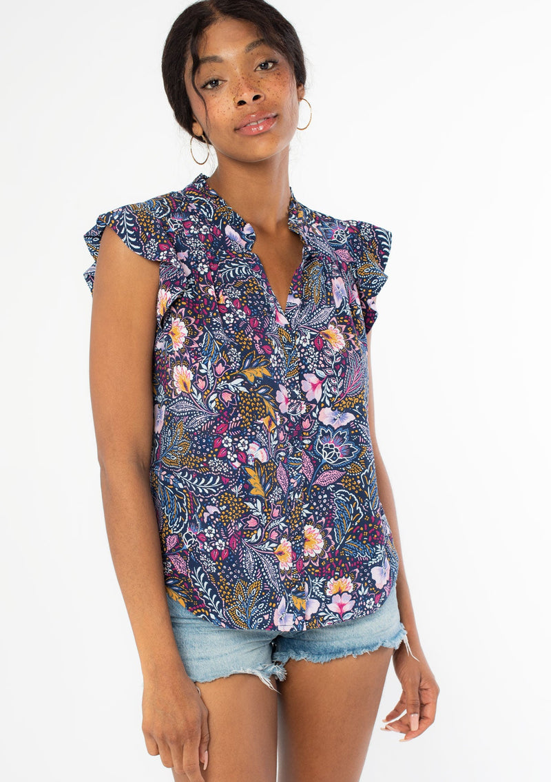 [Color: Navy/Berry] A front facing image of a black model wearing a navy blue and berry purple vintage floral print top with short flutter sleeves and a button front. 