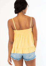 [Color: Sherbert] A woman wearing a yellow flowy bohemian tank top with crochet trim, gold toned hardware, and adjustable spaghetti straps.