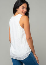 [Color: Off White] A back facing image of a brunette model wearing a white eyelet bohemian tank top. With a split v neckline and tassel ties. 