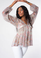 [Color: Blush/Aqua] A model wearing a sheer pink and blue paisley print bohemian blouse with long sleeves and ruffled accents. A dreamy Spring tunic top in sheer chiffon. 