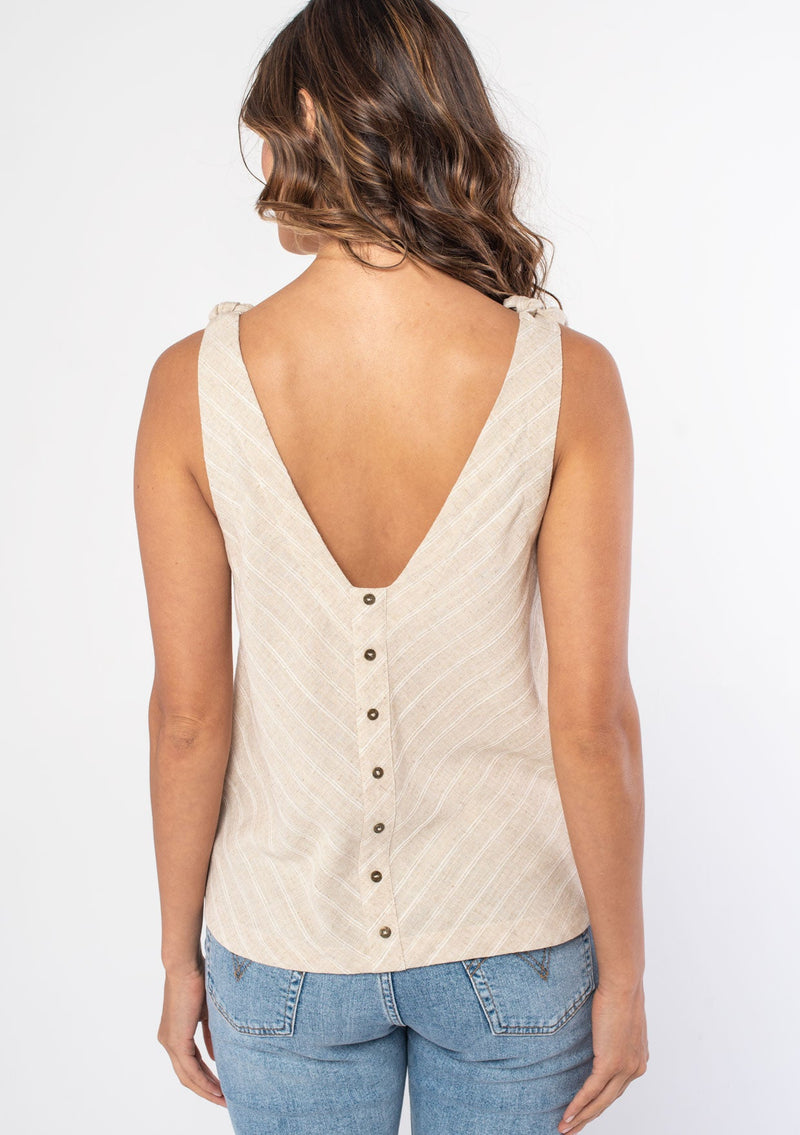 [Color: Natural] A model wearing a natural linen stripe flowy bohemian tank top with tie shoulder tank top straps and a button up back detail. 