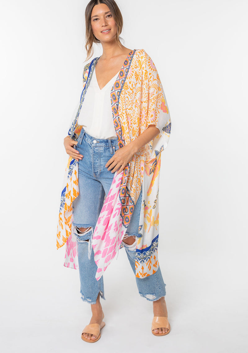 [Color: Sunkist/Off White] A model wearing a blue and yellow mixed bohemian print kimono. 