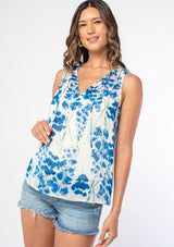 [Color: Cream/Blue] A model wearing a sheer chiffon sleeveless bohemian blouse in a white and blue watercolor floral print. 
