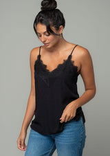 [Color: Black] A front facing image of a brunette model wearing a black clip dot camisole with a lace trim v neckline and adjustable spaghetti straps. 