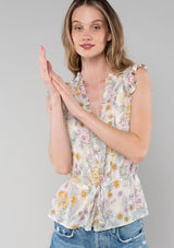 [Color: Natural/Pink] A front facing image of a blonde model wearing a lightweight bohemian spring peplum top in a pink floral print. With short ruffled sleeves, a ruffle trimmed v neckline, a self covered button front, and an adjustable drawstring waist with a tie. 