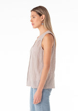 [Color: Dove] A side facing image of a blonde model wearing a spring sleeveless blouse in a grey eyelet lace chiffon. With a button front, a split v neckline, and a relaxed fit.