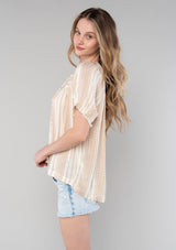 [Color: Natural/Tan] A side facing image of a blonde model wearing a bohemian spring top in a natural and tan stripe. With short puff sleeves, a split v neckline with ties, and a flowy relaxed fit. 