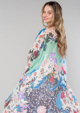 [Color: Natural/Coral] A half body side facing image of a blonde model wearing a lightweight bohemian kimono in a natural and coral mixed floral print. With half length kimono sleeves, an open front, and side slits. 