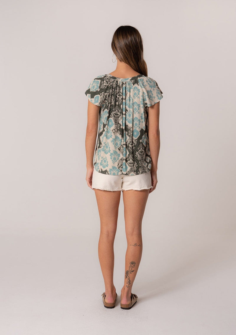 [Color: Black/Aqua] A back facing image of a brunette model wearing a classic short sleeve summer top in a green bohemian print. With short flutter sleeves and a v neckline. 