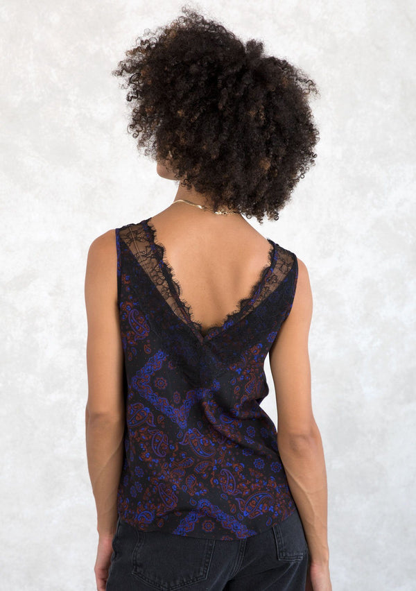 [Color: Black/Cobalt] A model wearing a vintage inspired lace tank top in a black and blue paisley bandana print. With a lace trimmed v neckline in front and back. 